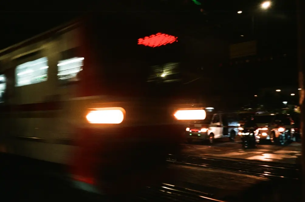Night Train Passing at Jakarta Railway Crossing