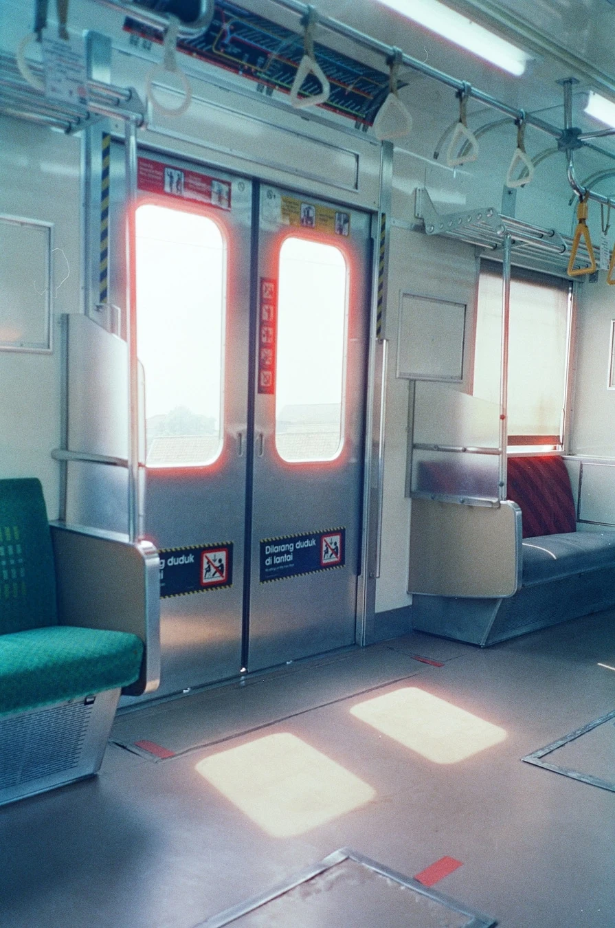 Empty Train Car with Glowing Doors. Shot with Olympus Mju II, Hoasca 800 film