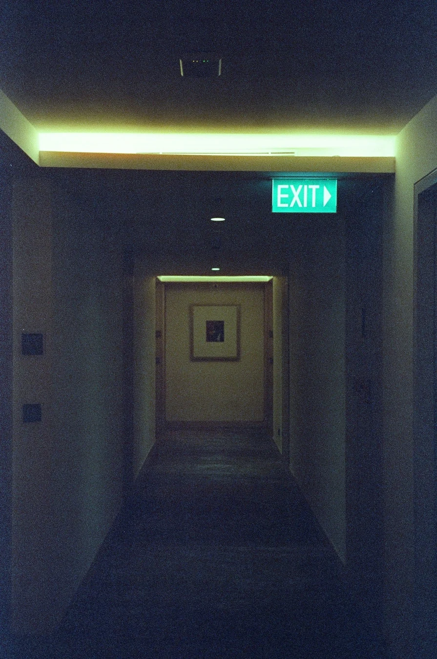 Illuminated Exit Through Dark Corridor. Shot with Olympus Mju II, Cira 800 film
