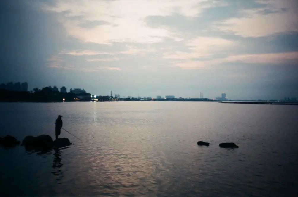 Solitary Evening Fisherman by the Harbour