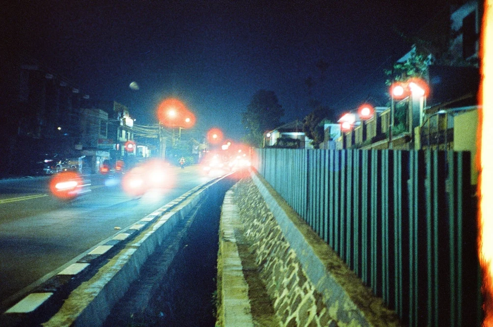 Red Lanterns Along the Drain. Shot with Olympus Mju II, Hoasca 800 film