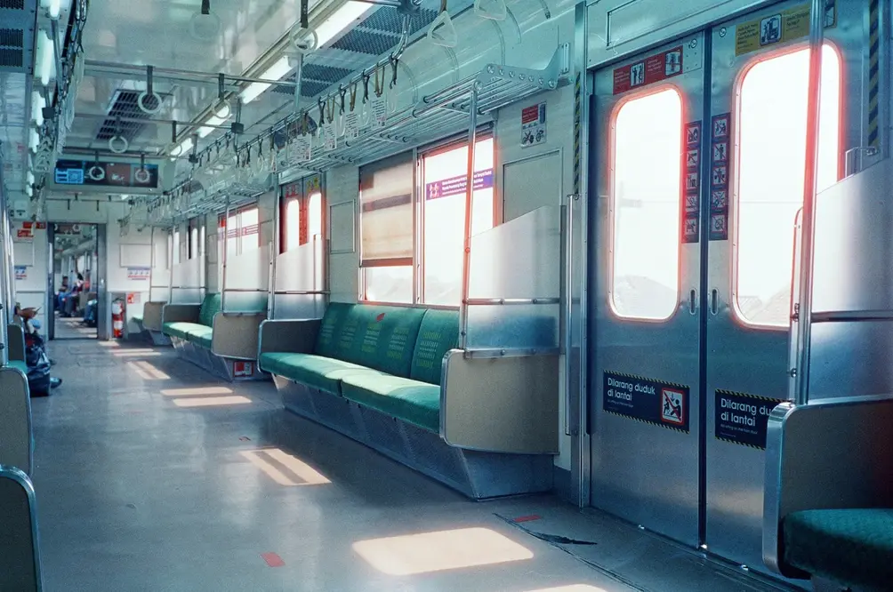 Sunlit Train Interior with Turquoise Seats